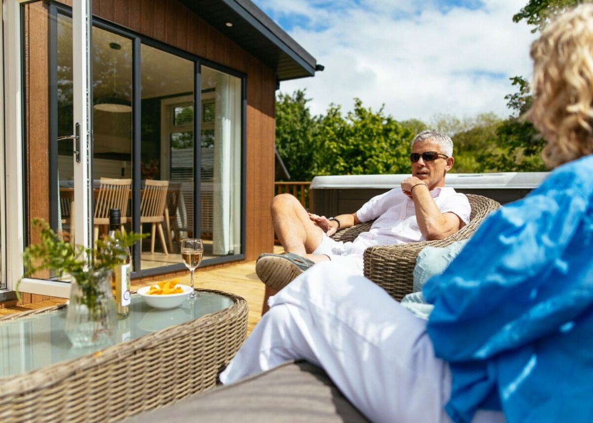 Couple sitting outside a Finlake Holiday Home