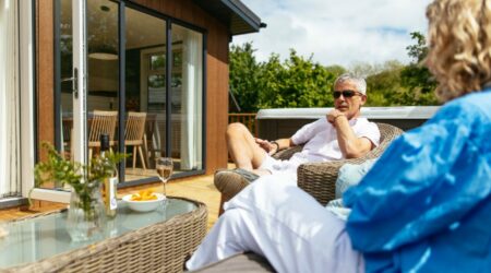 Couple sitting outside a Finlake Holiday Home