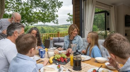 Family enjoying a meal out on their deck at Finlake Resort & Spa, Devon