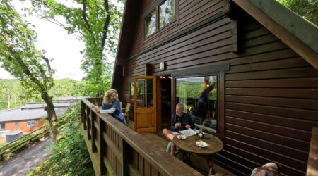 A-frame woodland lodge decking area with alfresco dinning setting