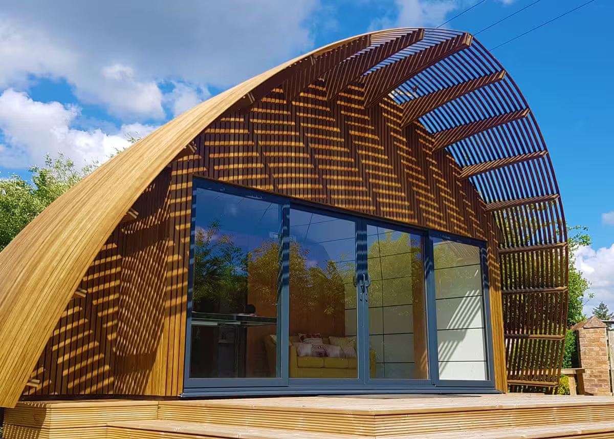 Curved architecture of Signature Pod Lodge with Large doors and patio