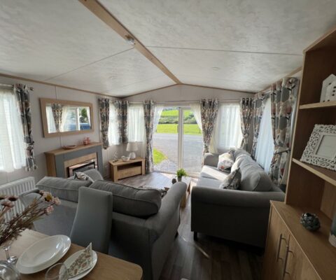 Two sofas in an open plan living kitchen and diner with wooden flooring